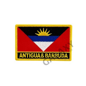 May include: An embroidered patch with the flag of Antigua and Barbuda. The flag features a red, white, and blue triangle with a yellow sun on a black background. The patch has a gold border and the words "Antigua & Barbuda" in gold lettering.