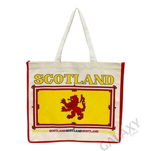 May include: A white canvas tote bag with red trim and a red and yellow Scottish flag design. The bag has the word "SCOTLAND" printed in yellow letters across the top and the words "SCOTLAND SCOTLAND SCOTLAND SCOTLAND" printed in smaller yellow letters across the bottom.