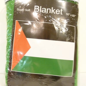 May include: A green, white, and black blanket with the words "Super Soft Blanket 50"x"60" printed on the packaging.