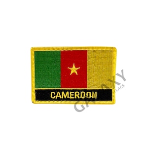 May include: A yellow, red, green, and gold embroidered patch with a yellow star in the center. The patch has the word "CAMEROON" written in black on a black background.