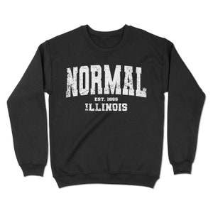 May include: Black sweatshirt with white text that reads "NORMAL EST. 1865 ILLINOIS".