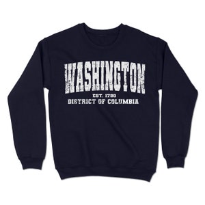 May include: Navy blue sweatshirt with a white distressed graphic that reads "WASHINGTON EST. 1790 DISTRICT OF COLUMBIA".