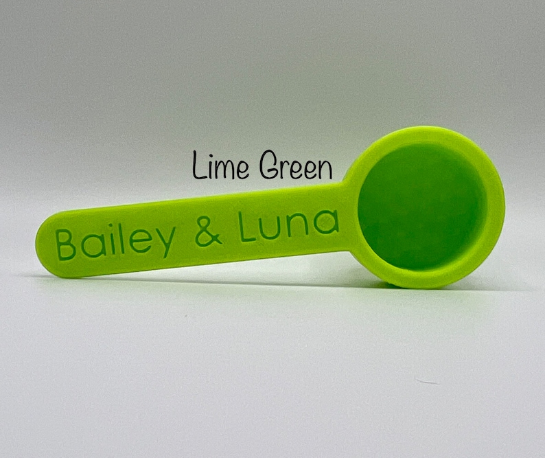 May include: Lime green measuring spoon with the text "Bailey & Luna" printed on the handle.