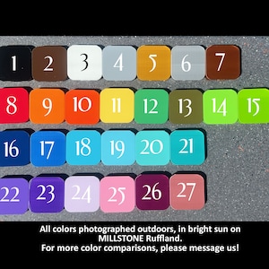May include: A color chart with 27 different colors, numbered 1 through 27. The colors are arranged in rows of 7, with the last row having only 3 colors. The colors are all solid and opaque. The chart is photographed outdoors in bright sunlight.