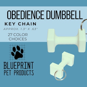 May include: White dumbbell keychains with silver key rings. The text on the image reads "OBEDIENCE DUMBBELL KEY CHAIN APPROX. 1.3" X .63" 27 COLOR CHOICES BLUEPRINT PET PRODUCTS". The background is blue.