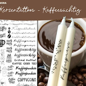 Può includere: Due candele bianche con testo nero che dice "Kaffeepause" e un motivo di chicchi di caffè. Le candele sono davanti a una tazza di caffè bianca con caffè marrone e uno sfondo di chicchi di caffè.
