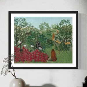 May include: A framed painting depicting a lush jungle scene with monkeys, birds, and vibrant red flowers. The painting is set against a blue sky and features a variety of green foliage.