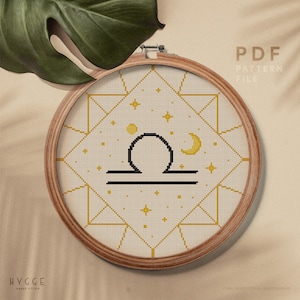 May include: A cross stitch pattern featuring the Libra zodiac sign in a geometric frame with a crescent moon and stars. The pattern is in a PDF format and is available for download.