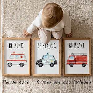May include: Three framed wall art prints featuring watercolor illustrations of emergency vehicles. The first shows an ambulance with the text BE KIND, the second a police car with BE STRONG, and the third a fire truck with BE BRAVE. Please note - frames are not included.