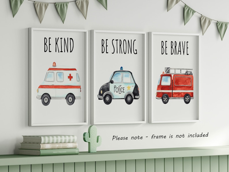 May include: Three framed wall art prints featuring watercolor illustrations of emergency vehicles. The first shows an ambulance with the text BE KIND, the second a police car with BE STRONG, and the third a fire truck with the text BE BRAVE.