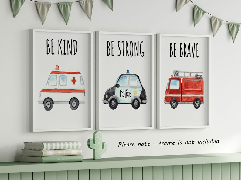 May include: Three framed wall art prints featuring watercolor illustrations of emergency vehicles. The first shows an ambulance with the text BE KIND, the second a police car with BE STRONG, and the third a fire truck with the text BE BRAVE.