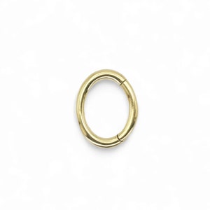 Surgical steel 1.2mm/16g oval clicker 5mm x 7mm for rook and daith piercings with 24ct gold plating. Sold singly.