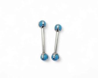 Barretta in titanio con filettatura interna e sfere con gemme turchesi incastonate a griffe per piercing da 1,6 mm/14 g per 12, 14 e 16 mm. Venduti singolarmente, non in coppia.