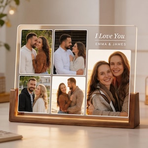 May include: A light-up photo display featuring six images of a couple, set in a clear acrylic panel. The panel is mounted on a wooden base. The text "I Love You" and names are printed on the panel.