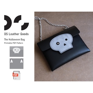 May include: Black leather bag with a silver chain strap and a gray skull applique. The bag is rectangular with a flap closure. The text "DS Leather Goods" and "The Halloween Bag Printable PDF Pattern" are visible.