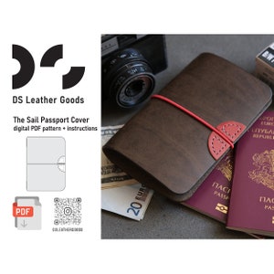 May include: A brown leather passport cover with a red elastic band and a red leather accent. The cover is sitting on top of a passport and some cash. The text "The Sail Passport Cover" is visible in the image.