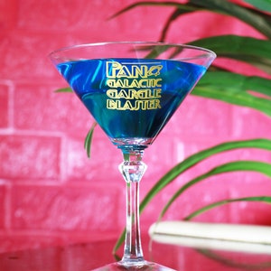 May include: A blue cocktail in a martini glass with the text "PANO GALACTIC GARGLE BLASTER" on the side.