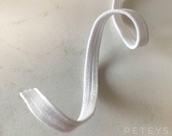 May include: White elastic band, a type of stretch fabric used for sewing and crafting projects.