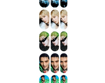 May include: Set of 10 nail decals featuring a male model in various poses and outfits. The decals feature a mix of black, white, green, and blue colors.