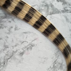 Blonde and black  raccoon tail hair extension