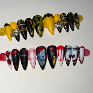 May include: Two sets of long, pointed false nails. The top set features yellow, black, and marble designs, with bee-shaped embellishments. The bottom set showcases horror-themed art, including a clown, blood drips, and red accents.