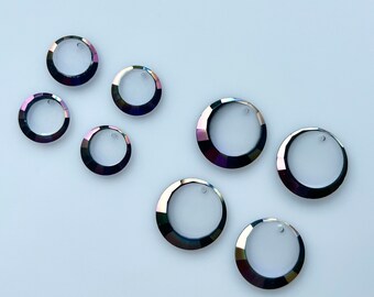 May include: Seven iridescent, faceted, round, glass, decorative, hanging ornaments with a hole at the top. The ornaments are a dark, iridescent blue-purple color.