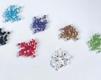 Swarovski Simplicity Cut Crystal Beads (24 pcs): 5310 Swarovski 4.5mm Simplicity Cut Crystals, tanzanite, aquamarine, golden shadow, peridot