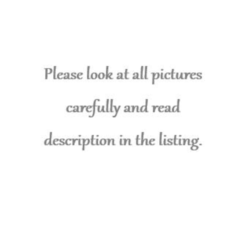 May include: A white ceramic mug with a black handle and the text "But First, Coffee" in a black, handwritten-style font. The mug is on a white surface.