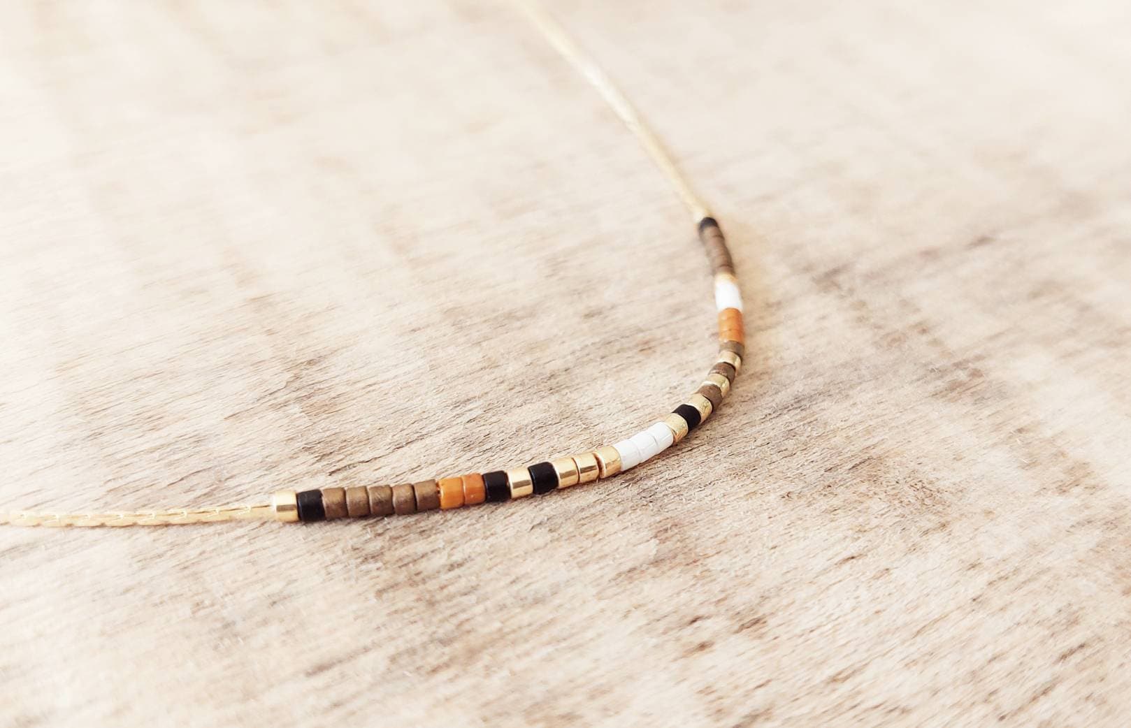 Ultra-fine short necklace made of Miyuki beads mounted on a gold-plated serpentine chain