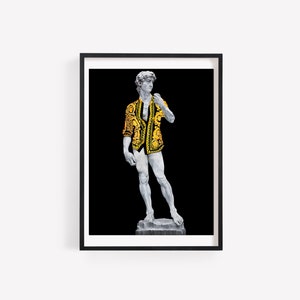 May include: A white marble statue of a man wearing a gold and black patterned shirt, standing on a stone base against a black background.