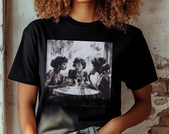 May include: A black short-sleeved t-shirt featuring a square graphic print on the chest. The print depicts a black and white illustration of three individuals sitting around a round table with glasses, engaged in conversation in a dimly lit setting.