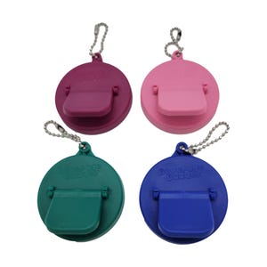 May include: Four round bottle stoppers with a flip-top lid and a keychain. The stoppers are in pink, purple, green, and blue.