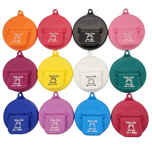 May include: Twelve round beverage bottle lids in various colors, including orange, red, black, pink, purple, yellow, white, green, blue, and magenta. Each lid has a white inscription that reads "Take Life one sip at a time" and a small graphic of two wine glasses.