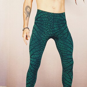 May include: Green leggings with a leaf pattern. The leggings are made of a stretchy material and have a high waist.