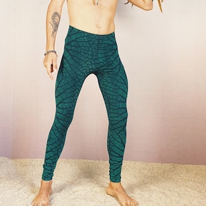 May include: Green leggings with a leaf pattern. The leggings are made of a stretchy fabric and have a high waist.