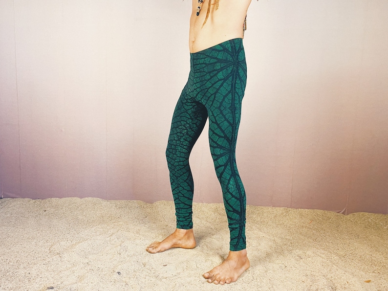 May include: Green leggings with a leaf pattern. The leggings are made of a stretchy fabric and have a comfortable fit.