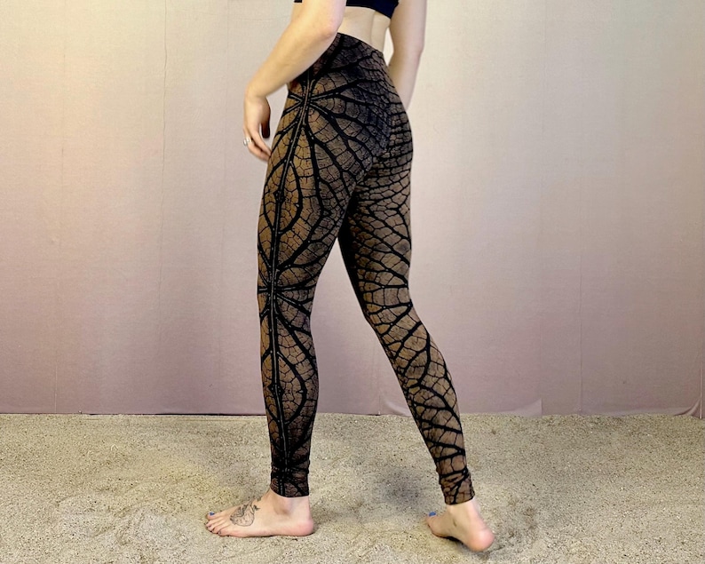 May include: Black and brown leggings with a geometric pattern resembling tree bark. The leggings are fitted and have a high waist.