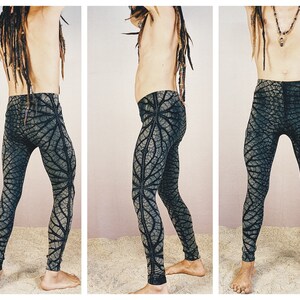 May include: Black and green patterned leggings with a leaf design. The leggings are fitted and have a stretchy fabric.