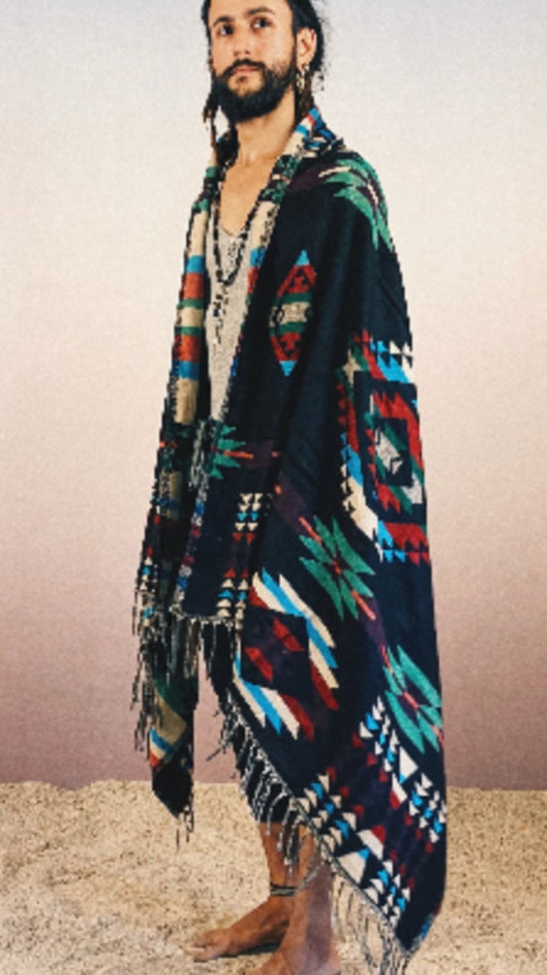 May include: A black and multi-colored woven shawl with fringe. The shawl features geometric patterns in shades of red, blue, green, and white.