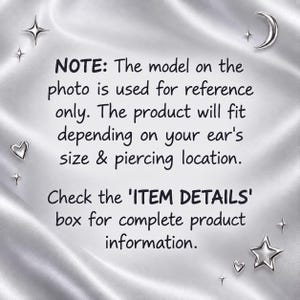 The image is a photo of a model wearing a product that will fit the person's ear's size and piercing location. The product is referred to as the "ITEM DETAILS" box for complete product information.