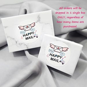 two white boxes with a marbled texture, each with a sticker that says "Happy Mail" and includes a heart and an envelope. The text above the boxes states that all orders will be shipped in a single box, regardless of how many items are purchased.