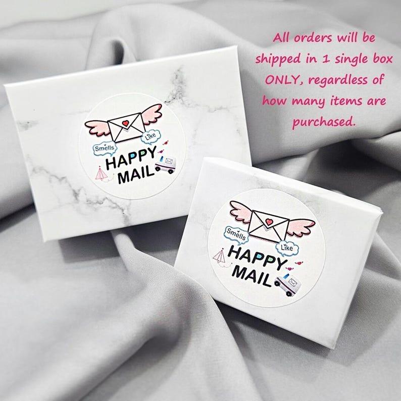 two white boxes with a marbled texture, each with a sticker that says "Happy Mail" and includes a heart and an envelope. The text above the boxes states that all orders will be shipped in a single box, regardless of how many items are purchased.