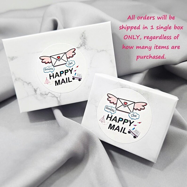 two white boxes with a marbled texture, each with a sticker that says "Happy Mail" and includes a heart and an envelope. The text above the boxes states that all orders will be shipped in a single box, regardless of how many items are purchased.
