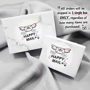 two white boxes with a marbled texture, each with a label that reads "Happy Mail" and includes a heart symbol. The boxes appear to be for shipping items, as indicated by the text "All orders will be shipped in 1 single box ONLY, regardless of how many items are purchased."