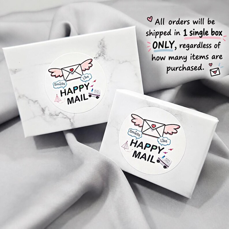 two white boxes with a marbled texture, each with a label that reads "Happy Mail" and includes a heart symbol. The boxes appear to be for shipping items, as indicated by the text "All orders will be shipped in 1 single box ONLY, regardless of how many items are purchased."