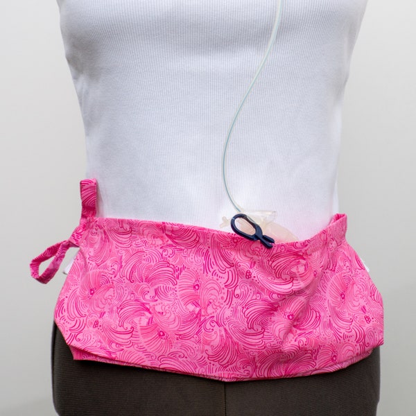 Surgical Drain Holder in Pink Swirls Pattern - Comfort first!  Trim belt to fit for up to 4x. Has 4 Inner pockets to securely hold drains.