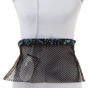 May include: A black mesh pouch with a floral patterned trim, designed to hold a medical bag or other items. The pouch is worn around the waist and has a clear tube running through it.