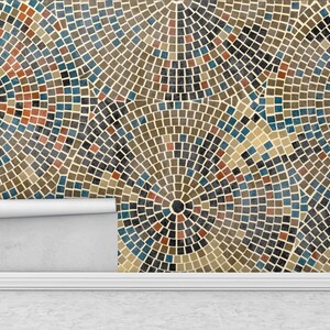 May include: A close-up of a wallpaper with a geometric pattern of brown, blue, and red squares arranged in concentric circles. The wallpaper is peeling off the wall, revealing a white wall underneath.