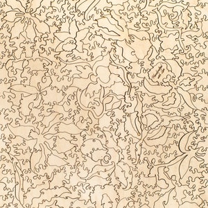 May include: A laser-cut wooden jigsaw puzzle featuring a floral design with intricate details. The puzzle is made of natural wood and has a light brown color. The puzzle is called "Handcrafted with Love".