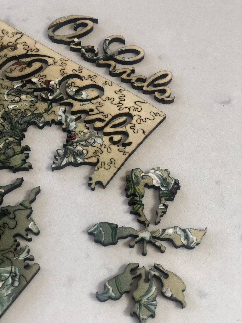 May include: A wooden jigsaw puzzle with a floral design and the word "Grandma" on the edge of the puzzle pieces.